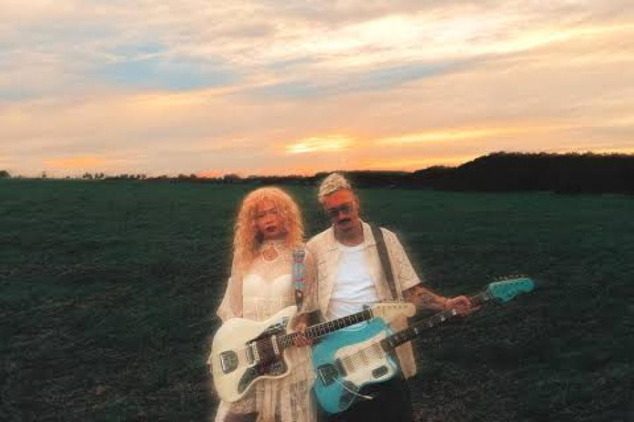 chardonnay & martyn standing next to each other with guitars